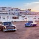 Two 1955 Chevys at sundown in front of airplane hanger