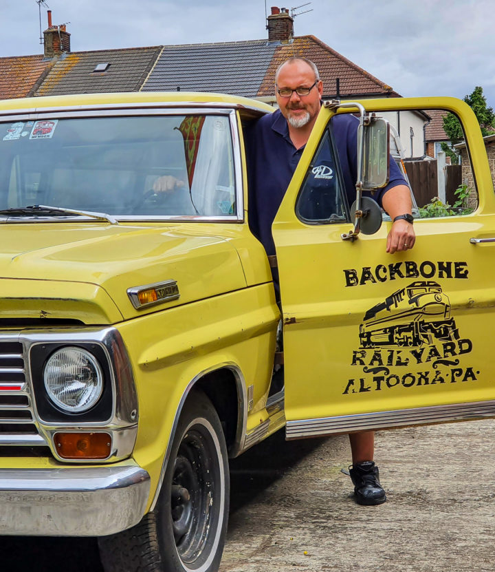 Artist Paul Hurley stands with his Ford pickup